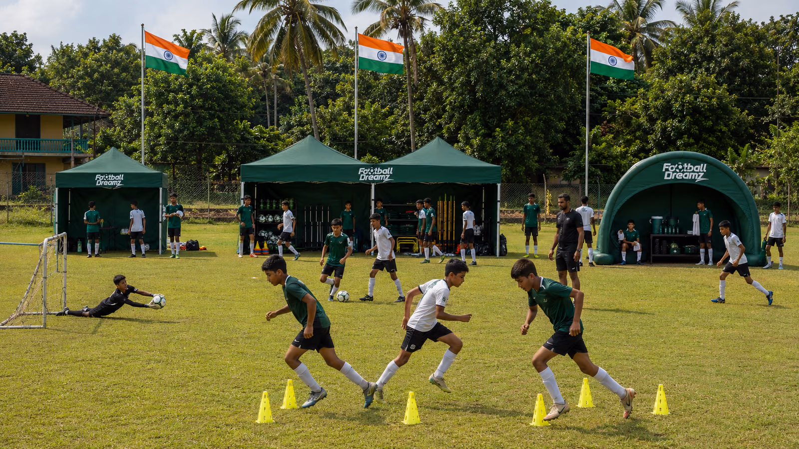 Young players running a drill between cones at a training camp