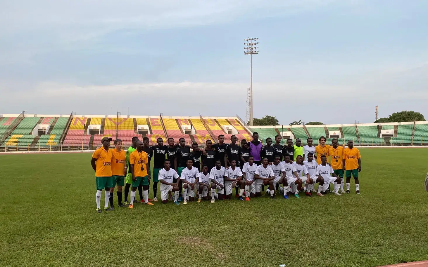 Full Football Dreamz squad and coaching staff on the pitch