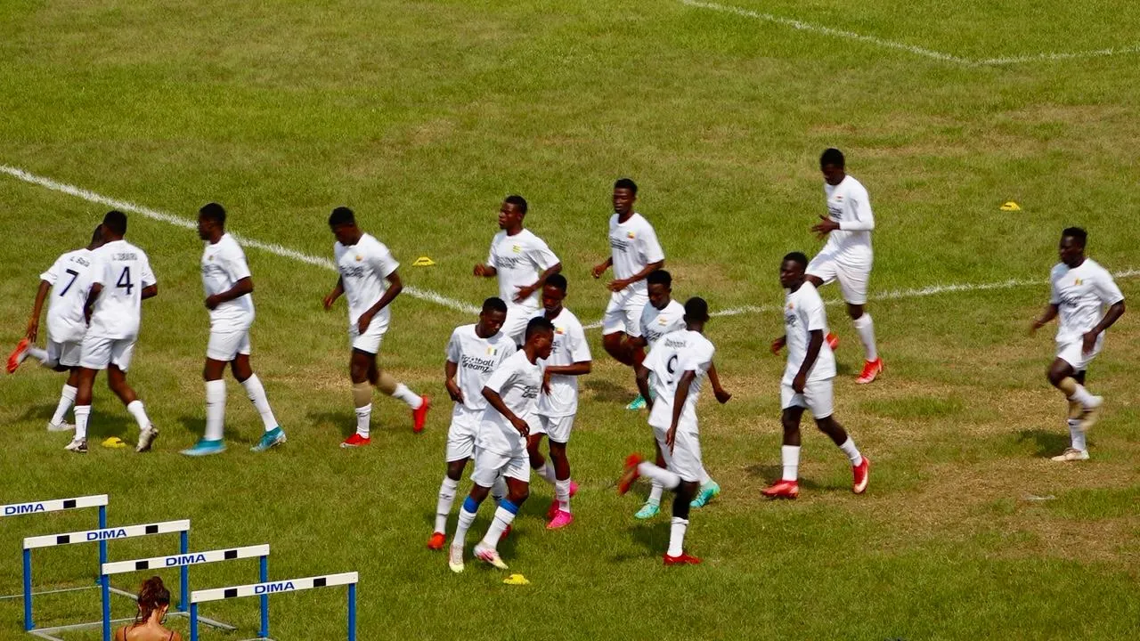 The squad jogging across the pitch in a warm-up